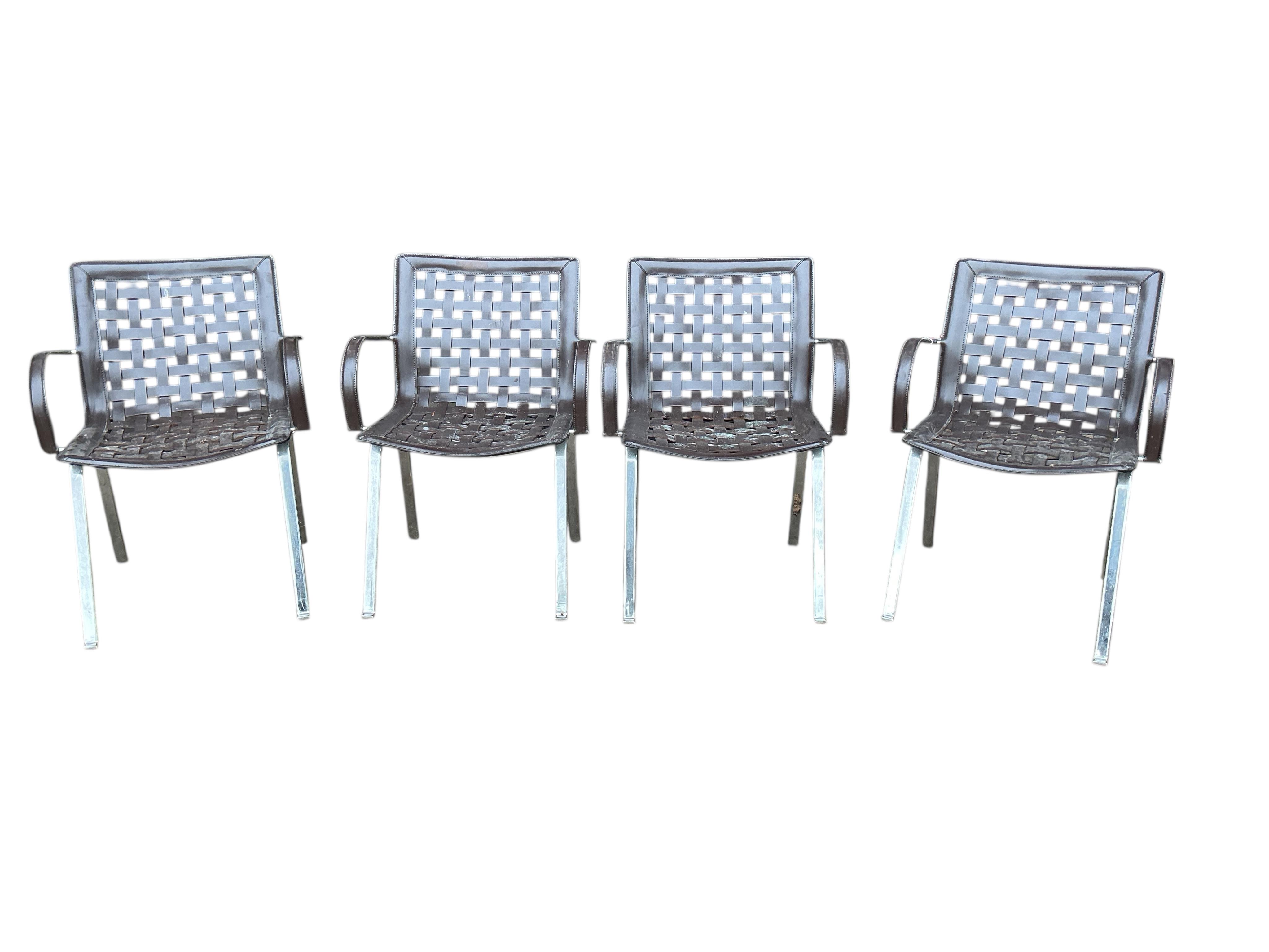 In the manner of Gancarlo for Faselhh: A set of four chrome and brown leather elbow chairs, width 62cm, depth 54cm, height 82cm